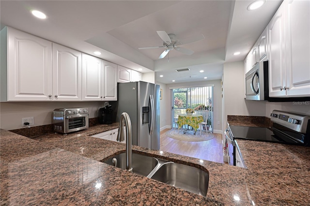 kitchen with ceiling fan, stainless steel appliances, sink, and white cabinets