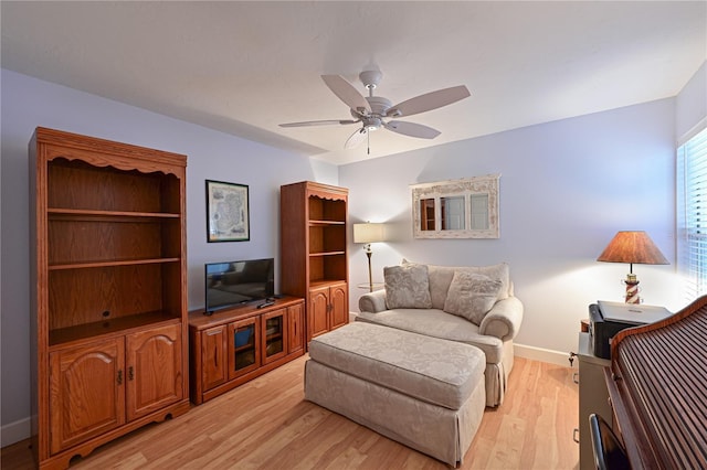 living room featuring ceiling fan and light hardwood / wood-style flooring