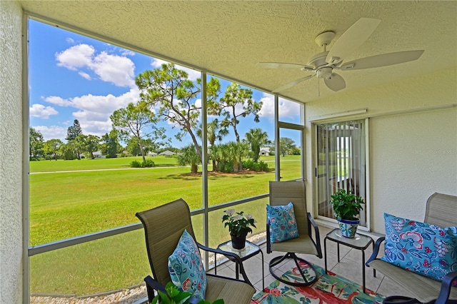 sunroom featuring ceiling fan