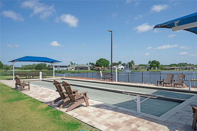 view of pool featuring a water view