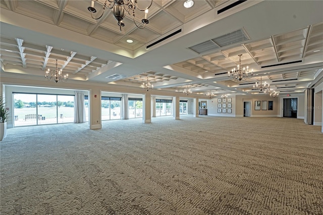 spare room with an inviting chandelier, coffered ceiling, and carpet floors