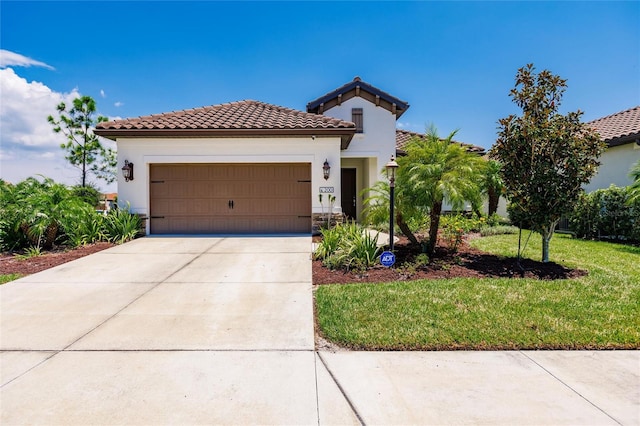 mediterranean / spanish home featuring a garage and a front lawn