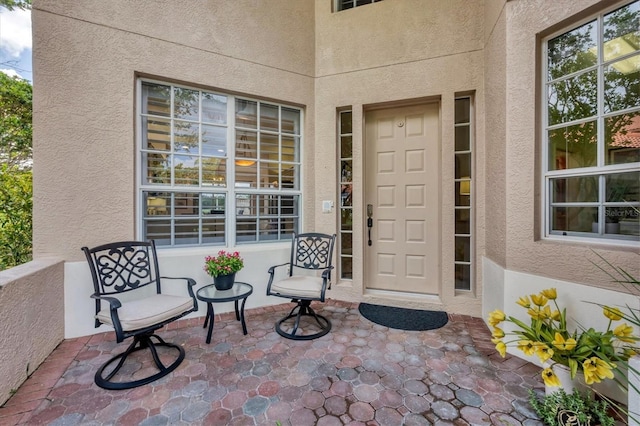 entrance to property featuring stucco siding