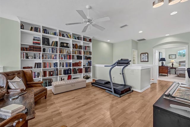 sitting room featuring ceiling fan, arched walkways, light wood-style flooring, recessed lighting, and visible vents