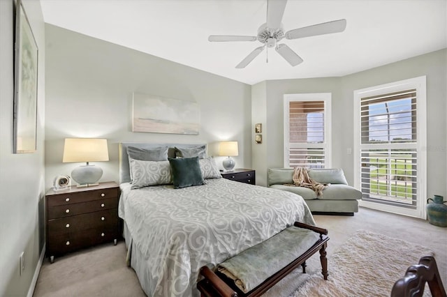 carpeted bedroom with ceiling fan and multiple windows