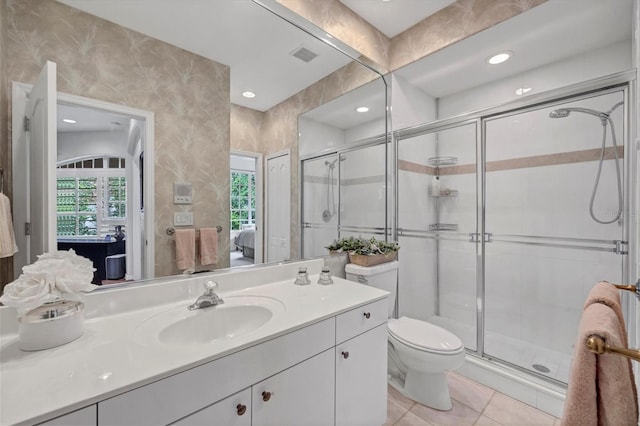 bathroom featuring an enclosed shower, toilet, vanity, and tile patterned floors