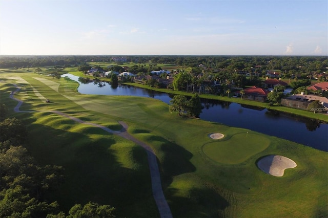 drone / aerial view featuring view of golf course and a water view