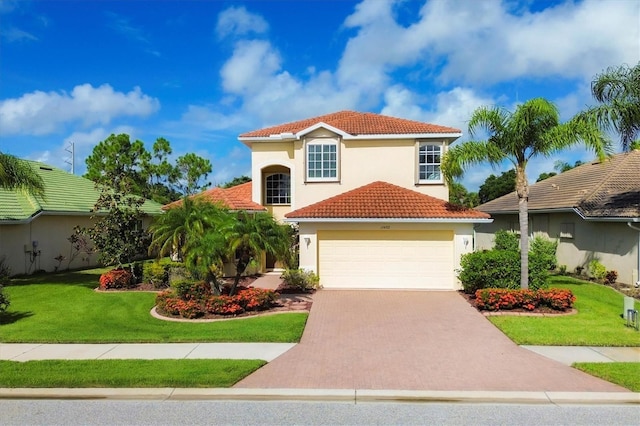 mediterranean / spanish-style house featuring decorative driveway, a tile roof, stucco siding, a front yard, and a garage