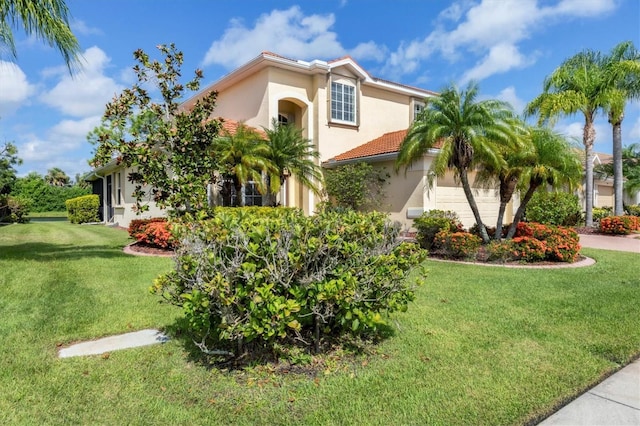 view of front of house with a garage, stucco siding, a tile roof, and a front yard