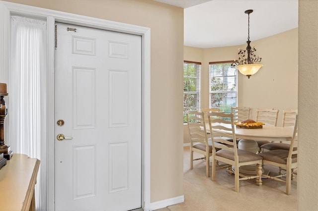 entrance foyer with light carpet and baseboards