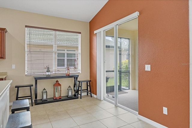 entryway with baseboards and tile patterned floors