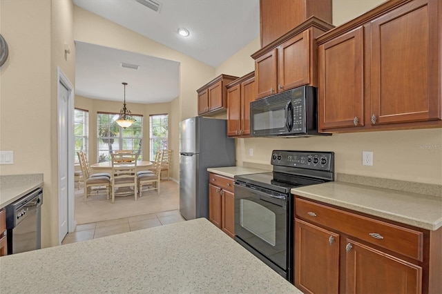 kitchen with lofted ceiling, visible vents, light countertops, brown cabinets, and black appliances