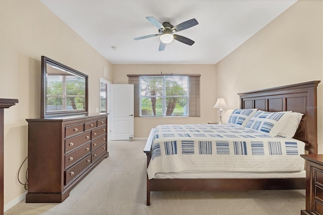 bedroom featuring baseboards, a ceiling fan, and light colored carpet