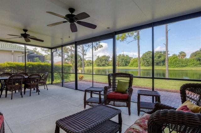 sunroom with a water view and a ceiling fan