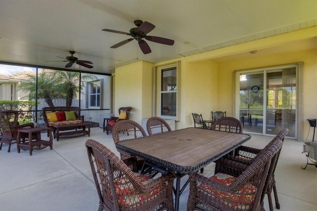 view of patio with outdoor dining space, ceiling fan, and an outdoor living space