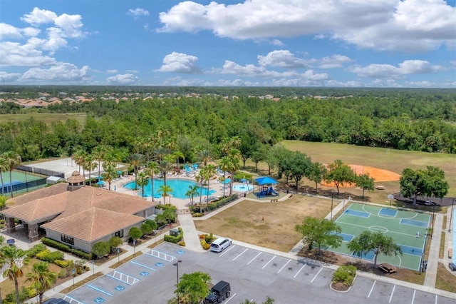 birds eye view of property with a view of trees