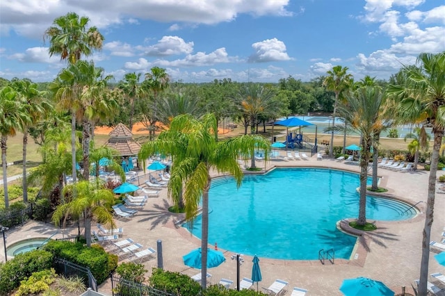 community pool featuring a patio area and fence