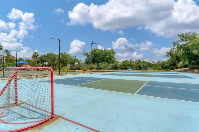 view of tennis court featuring community basketball court