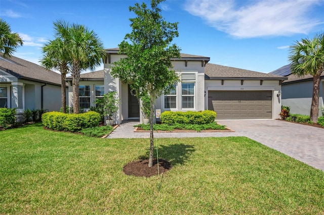 view of front of property with a garage and a front lawn