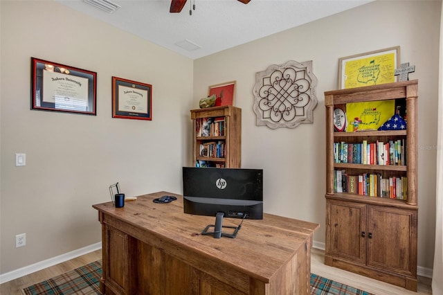 office with ceiling fan and light hardwood / wood-style flooring