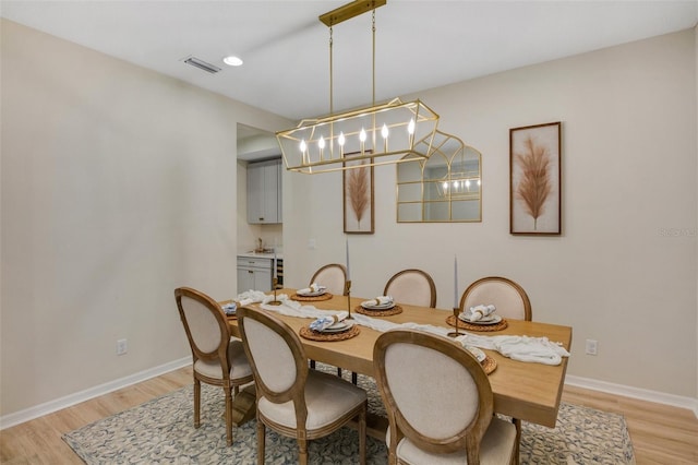 dining space featuring a chandelier and light hardwood / wood-style floors