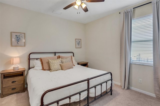 bedroom with ceiling fan and light colored carpet