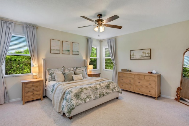 bedroom with light carpet and ceiling fan