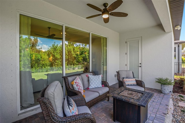 view of patio featuring an outdoor living space with a fire pit and ceiling fan