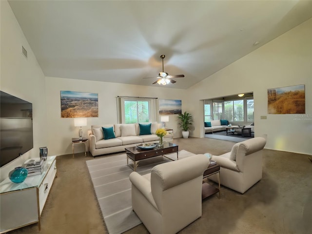 carpeted living room featuring ceiling fan, a wealth of natural light, and vaulted ceiling