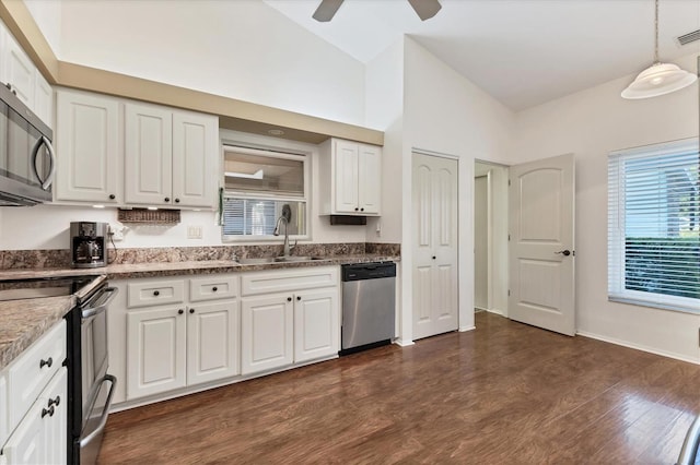 kitchen featuring stainless steel appliances, sink, lofted ceiling, ceiling fan, and white cabinets