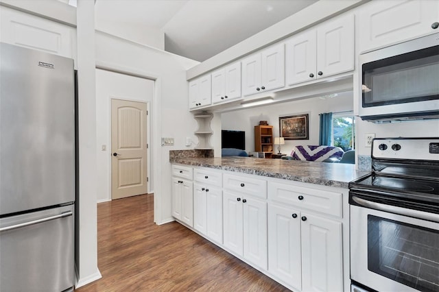 kitchen with white cabinetry, dark wood-type flooring, stainless steel appliances, and vaulted ceiling