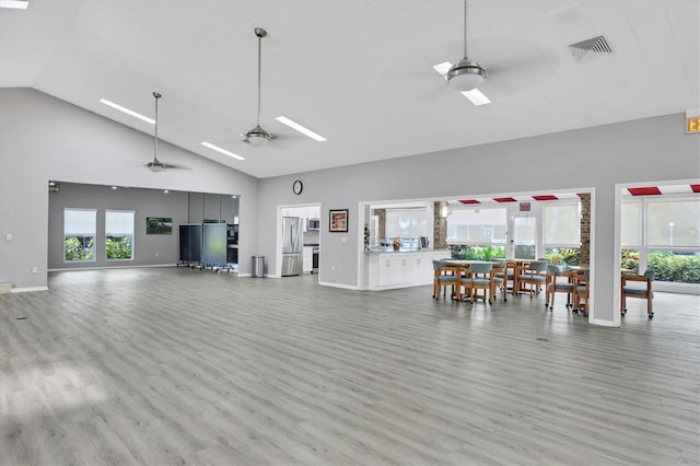 living room with ceiling fan, high vaulted ceiling, and hardwood / wood-style flooring