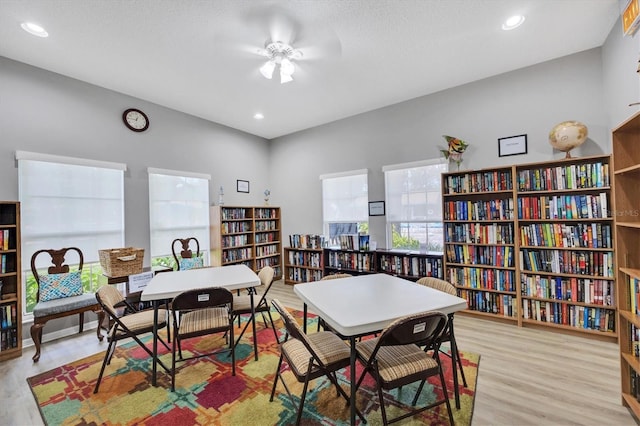 interior space with ceiling fan, light hardwood / wood-style floors, and a textured ceiling