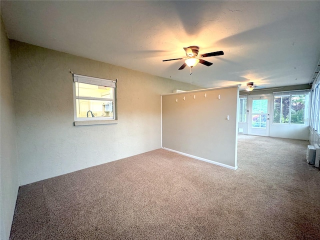 carpeted empty room with ceiling fan