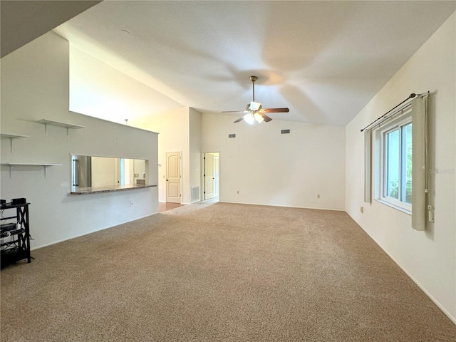 unfurnished living room with lofted ceiling, ceiling fan, and carpet flooring