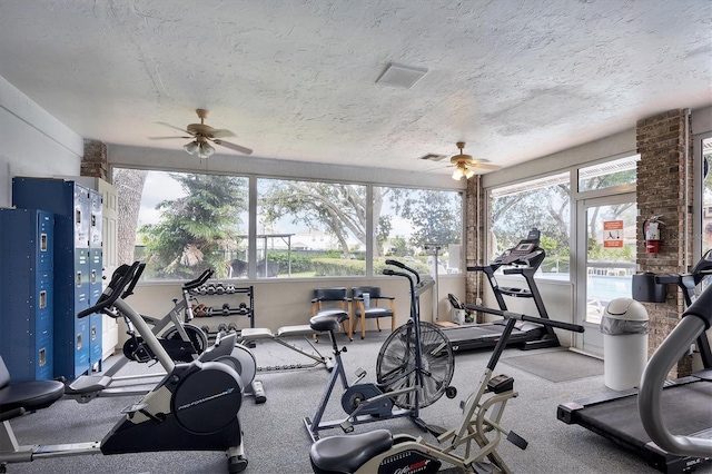 workout area featuring a textured ceiling and ceiling fan