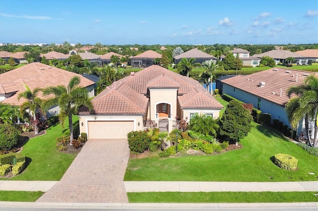 view of front of property with a front lawn and a garage