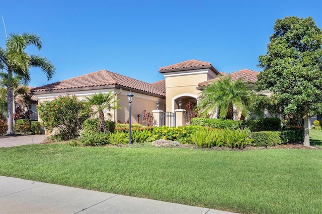 mediterranean / spanish-style house featuring a front yard