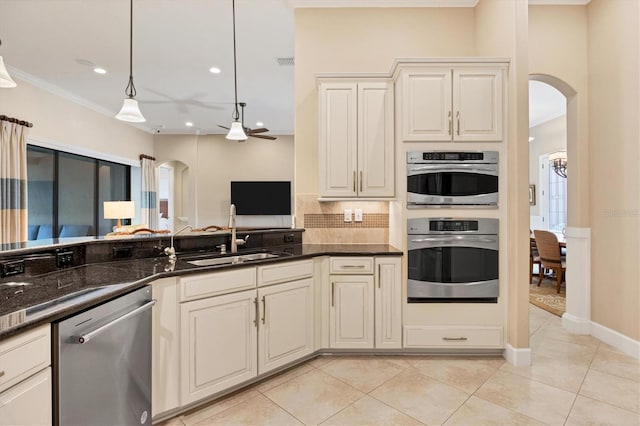 kitchen featuring sink, stainless steel appliances, pendant lighting, and light tile patterned flooring