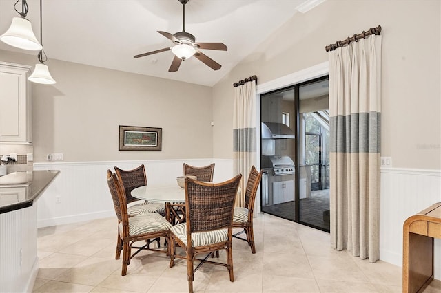 tiled dining area featuring ceiling fan and lofted ceiling