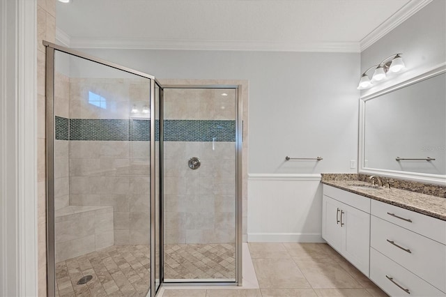 bathroom featuring tile patterned floors, an enclosed shower, vanity, and ornamental molding