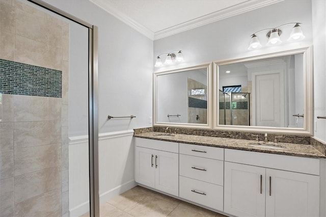 bathroom featuring tile patterned flooring, double vanity, and crown molding