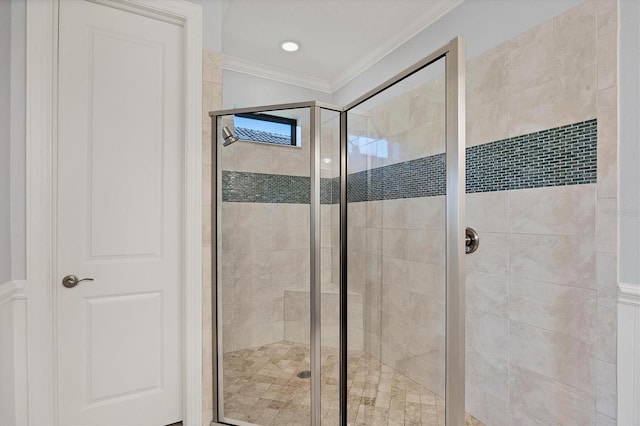 bathroom featuring crown molding and a shower with door