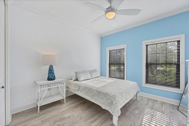 bedroom with ceiling fan, hardwood / wood-style flooring, and crown molding