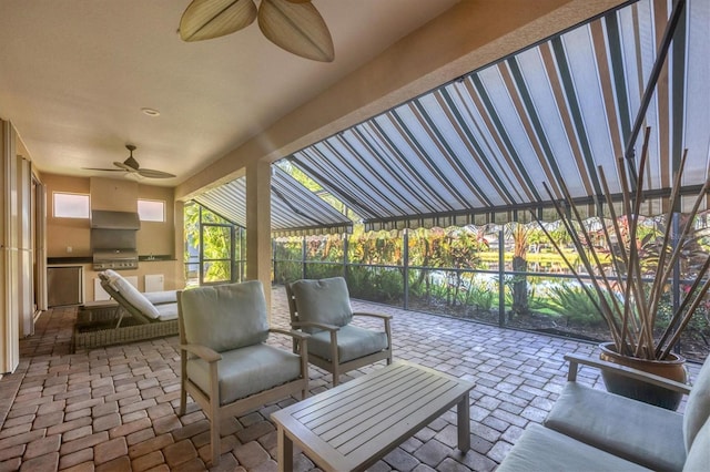 view of patio with ceiling fan, an outdoor kitchen, and a grill