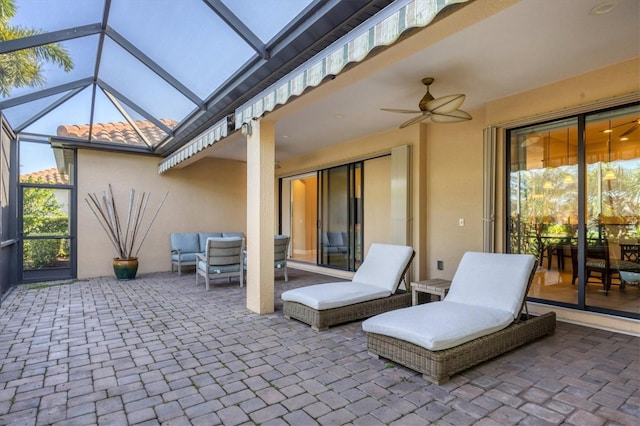 view of patio featuring ceiling fan and a lanai