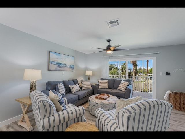 living room featuring ceiling fan and light wood-type flooring