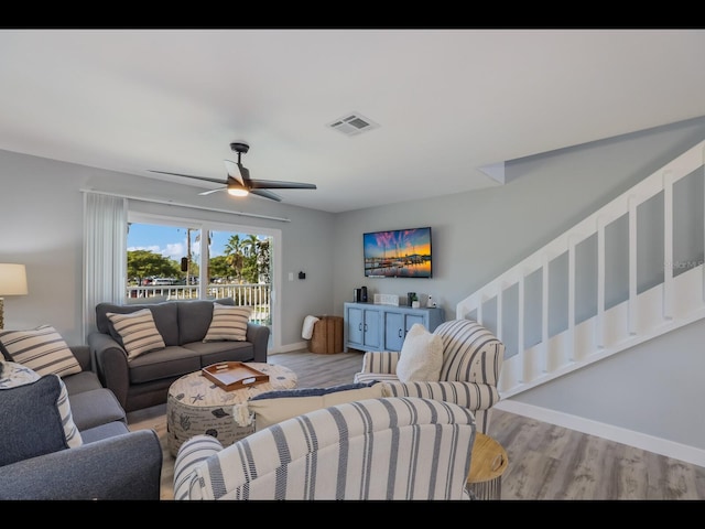 living room with ceiling fan and hardwood / wood-style floors