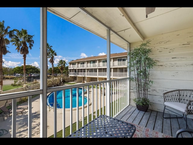 balcony with a fenced in pool