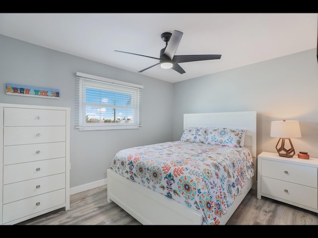 bedroom with ceiling fan and light wood-type flooring